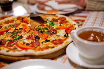 pepperoni pizza and drinks on the table