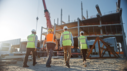 Diverse Team of Specialists Inspect Commercial, Industrial Building Construction Site. Real Estate...