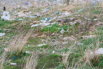 Ecological pollution of nature. Plastic bag tangled in plants against the backdrop of the mountains. Global environmental pollution. Recycling, clearing the land from plastic debris.