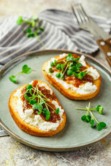 Canape or crostini with toasted baguette, cottage cheese, fig jam