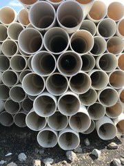 Looking At Stack Of White PVC Pipes