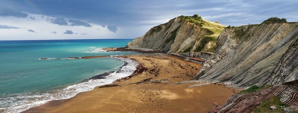 View of Itzurun beach in Zumaia on a stormy day.Dragostone filming location of Game of Trones