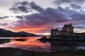 Eilean Donan Castle with colourful sunset in background - Dornie, Scotland - United Kingdom.