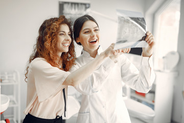 Woman in the dentist's office. Doctor in a uniform.