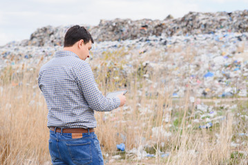 garbage recycling concept. man on dumpster. Keeping the environment clean. Ecological problems.