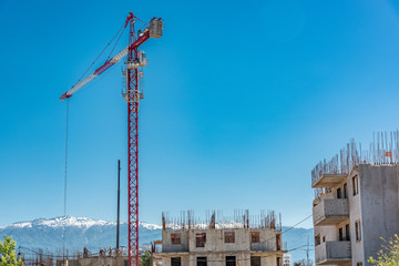 Tower crane on a construction site in the mountains mountains