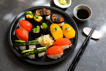 Selection of vegan sushi with tomatoes, aubergine, asparagus and pepper