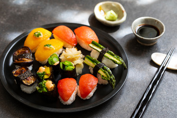 Selection of vegan sushi with tomatoes, aubergine, asparagus and pepper