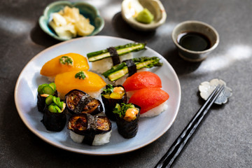 Selection of vegan sushi with tomatoes, aubergine, asparagus and pepper