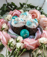 Decorated colorful merengue on the Easter pie. Blue eggs, pink roses.