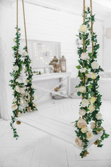 Swing decorated with artificial flowers