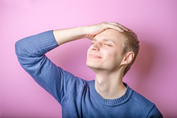 Man holding head and looking up, head and shoulders, portrait