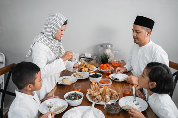 happy muslim asian family having sahoor or sahur breakfast during ramadan