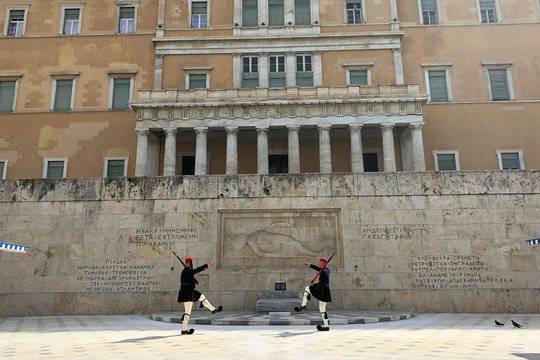 Athens, Greece - March 16, 2018: Evzones in front of the Monument of the Unknown Soldier, next to the Greek Parliament, Syntagma square.