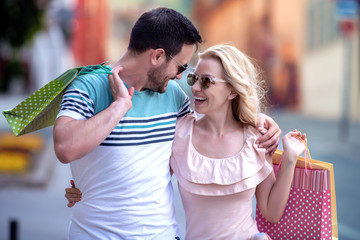 Young attractive couple with shopping bags