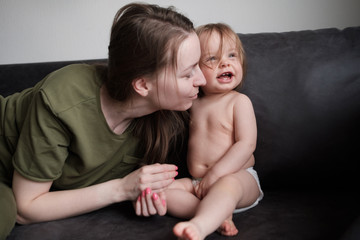family, child and parenthood concept - happy smiling young mother with little baby at home