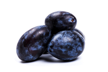 Fresh blue plums, isolated on white background, in close-up.