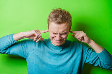 young man gesturing with fingers against his temple