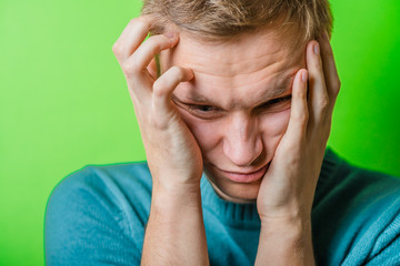 Fototapeta premium A young man having a headache