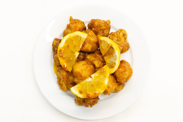 Chinese Lemon Chicken on white background.This Chinese Lemon Chicken is made with boneless skinless chicken thigh, cut into bite-size pieces and fried until golden and crispy.