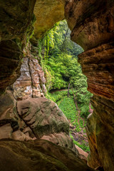 From Within The Rock House - In the woods of Hocking Hills State Park, Ohio, Rock House is a natural twenty-five foot tall cave, on the side of a sandstone cliff. This view looks out one end of its tw