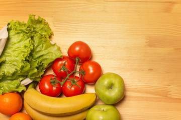 Food delivery service. Healthy food on wooden table. Buy online during quarantine. Tomatos, apples, bananas, oranges, salad. High quality photo. Stay home, be safe.