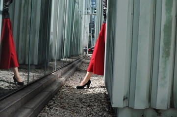 leg in a shoes and red dress