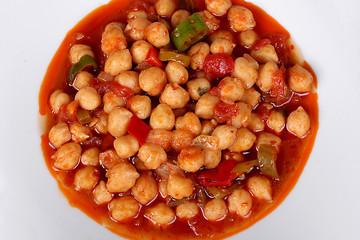 excellent turkish food chickpeas on white plate with spicy from top view on wooden table
