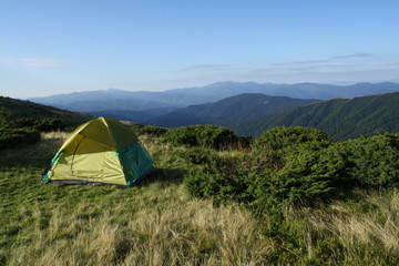 morning on top of mountain, travelling with tent, landscape, between blue clear sky and green grass
