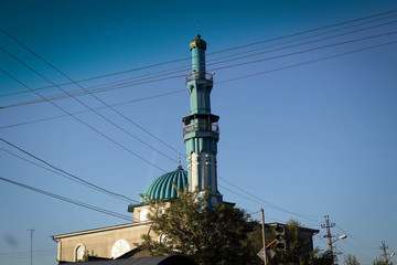 Obraz premium Minaret view between wires, Osh city suburbs, Kyrgyzia