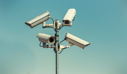 Security cameras, CCTV, video surveillance against blue sky.