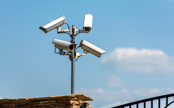 Security cameras, CCTV, video surveillance against blue sky.