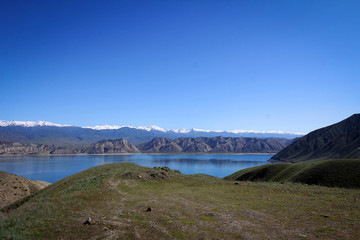 Toktogul Reservoir and Tian Shan mountains view by spring, Kyrgyzia