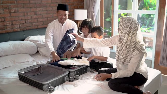 Muslim family prepare clothes and suitcase for carried when mudik go to the village