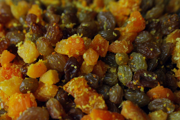 Raisins, dried apricots and candied fruits, cropped shot. Abstract food background.
