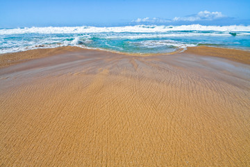 Queen's Pond Draining Into The Pacific Ocean at Low Tide on Polihale Beach, Polihale Beach State Park, Kauai, Hawaii, USA