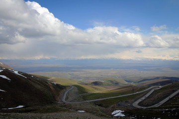Too Ashuu mountain pass scenic view by spring with white peaks, Kyrgyzia