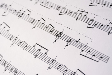 Close up musical notes printed on the paper. Selective focus. Musical notation