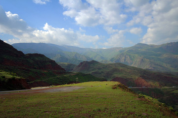 Scenic road view of green valleys and Tian Shan range, Central Kyrgyzia