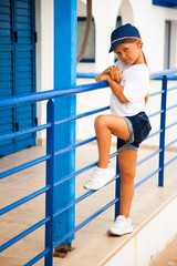 Cute 5-years old girl standing and modeling outdoor