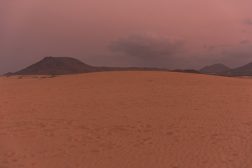 Fototapeta na wymiar colorful sunset over desert sand dunes