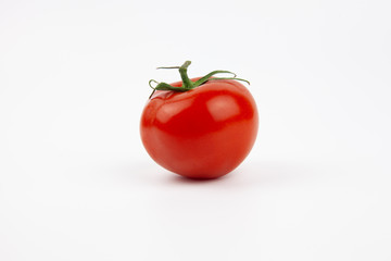 Isolated red, fresh and juicy tomato on a white background. Vegetables for fresh salad.
