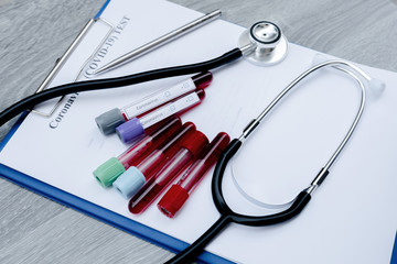 The picture of blood tube of coronavirus test and stethoscope in white background