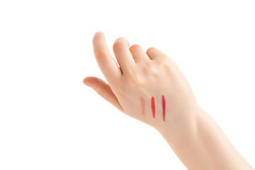 Obraz premium Lipstick stripes on a woman hand. Red lipstick. Isolated on white background.