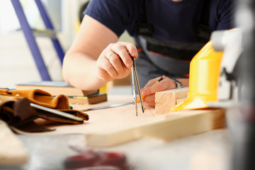 Arms of worker making structure plan on scaled paper closeup. Manual job, DIY inspiration, improvement job, fix shop graphic, joinery startup, workplace idea, designer career, wooden bar, ruler