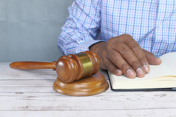 Close up of gavel, book on black background 
