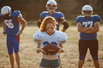 Fototapeta premium American football woman player in action on the stadium.