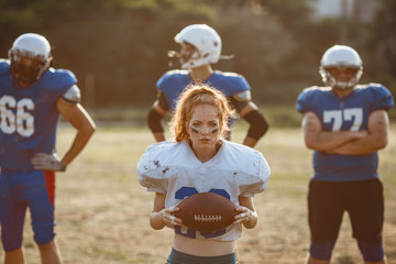 American football woman player in action on the stadium.