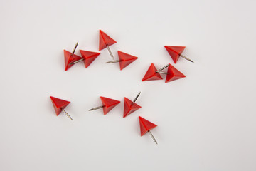 Red paper pins on a white background. A tool for attaching paper to the wall.