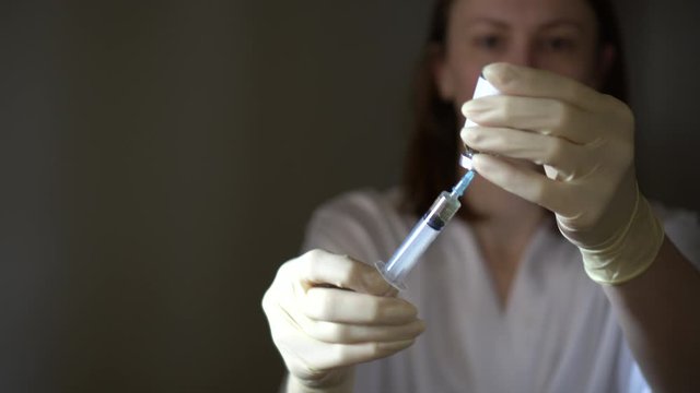 Self-injection of antibiotics. Female preparing needle for injecting her buttocks. Woman injecting buttocks.